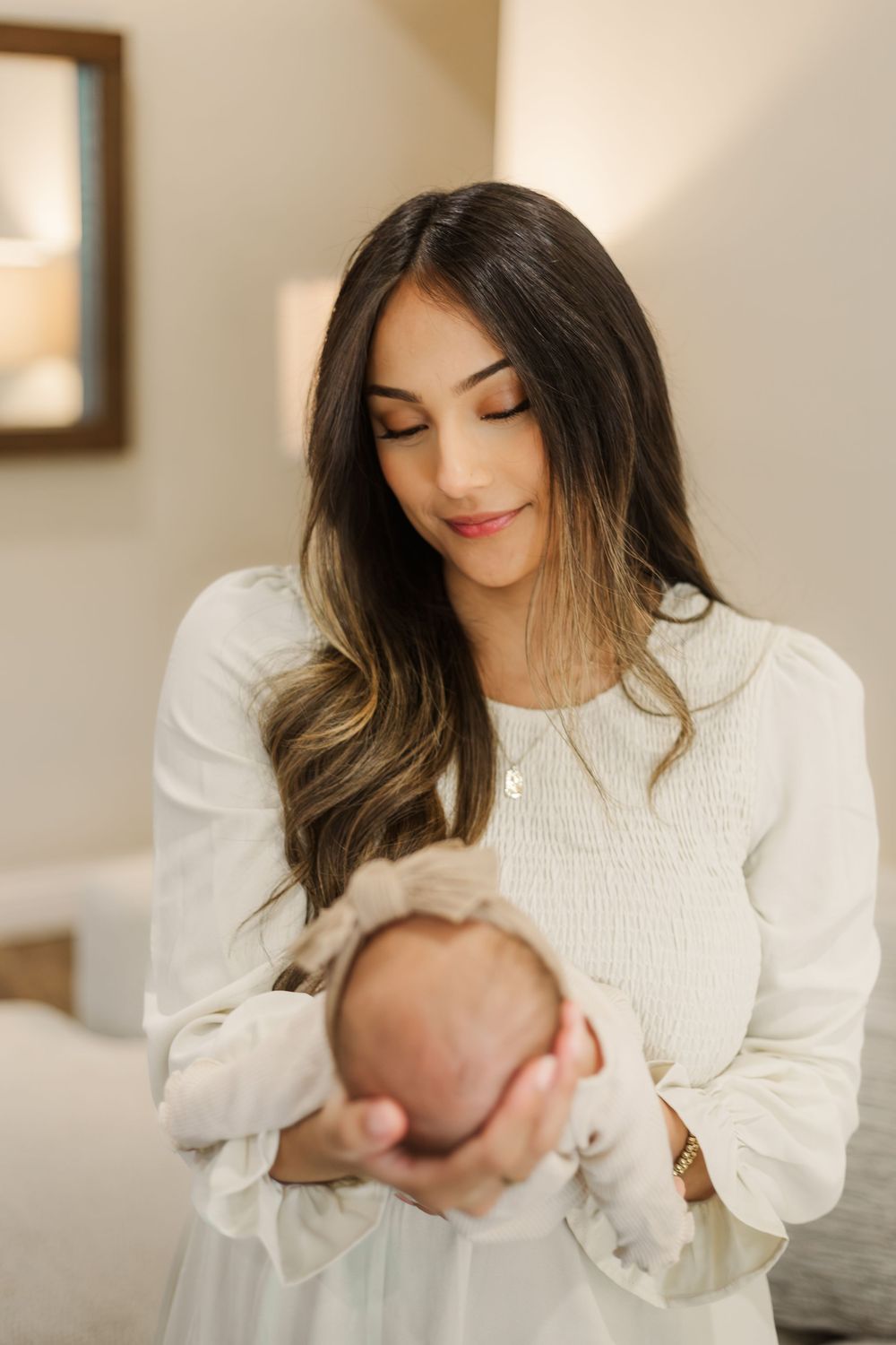 A series of tender moments captured between parent and infant in soft, natural light against a neutral background.