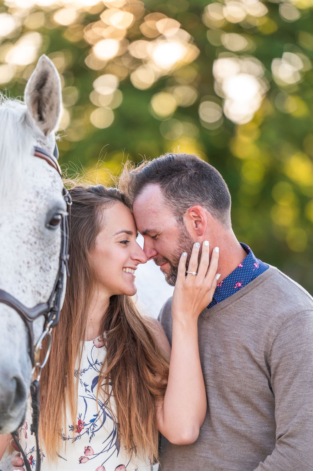 A romantic moment captured with a white horse against a soft bokeh background during golden hour.
