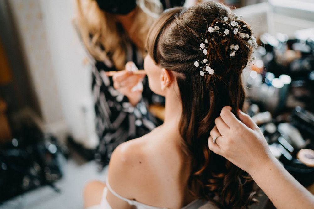 Close-up of elegant bridal hairstyle with delicate floral accessories.
