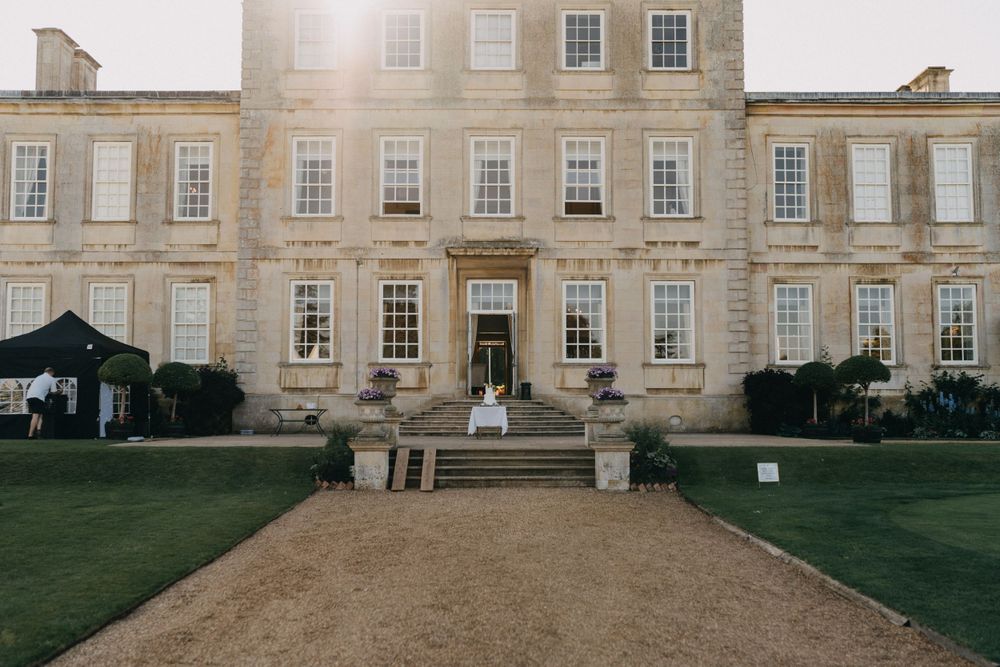 A grand Georgian style mansion with symmetrical windows and manicured grounds.