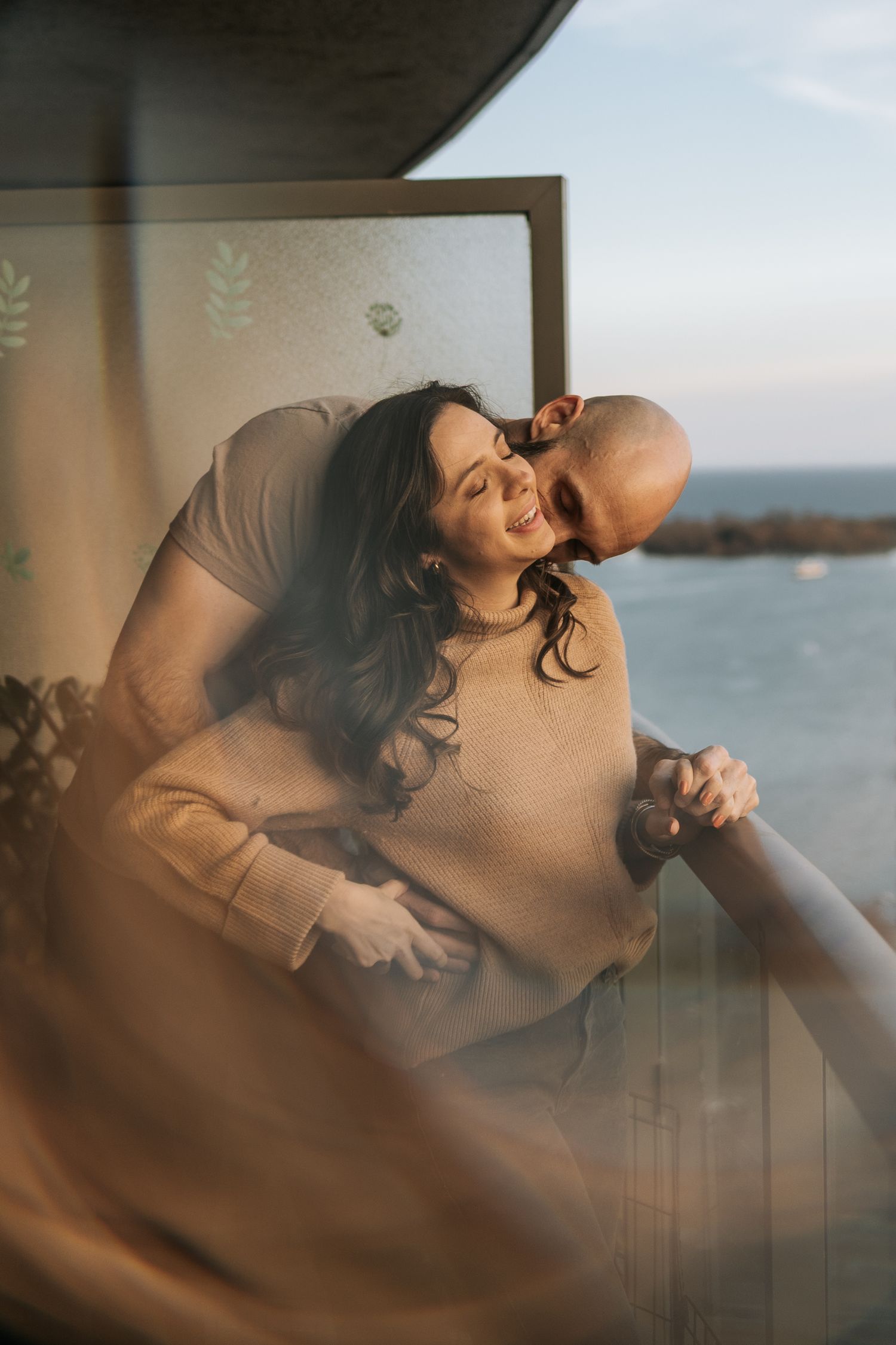 Couple in their balcone admiring the sunset