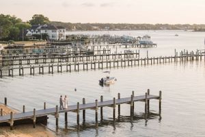 Aerial view of wooden docks and boats on a peaceful waterfront.