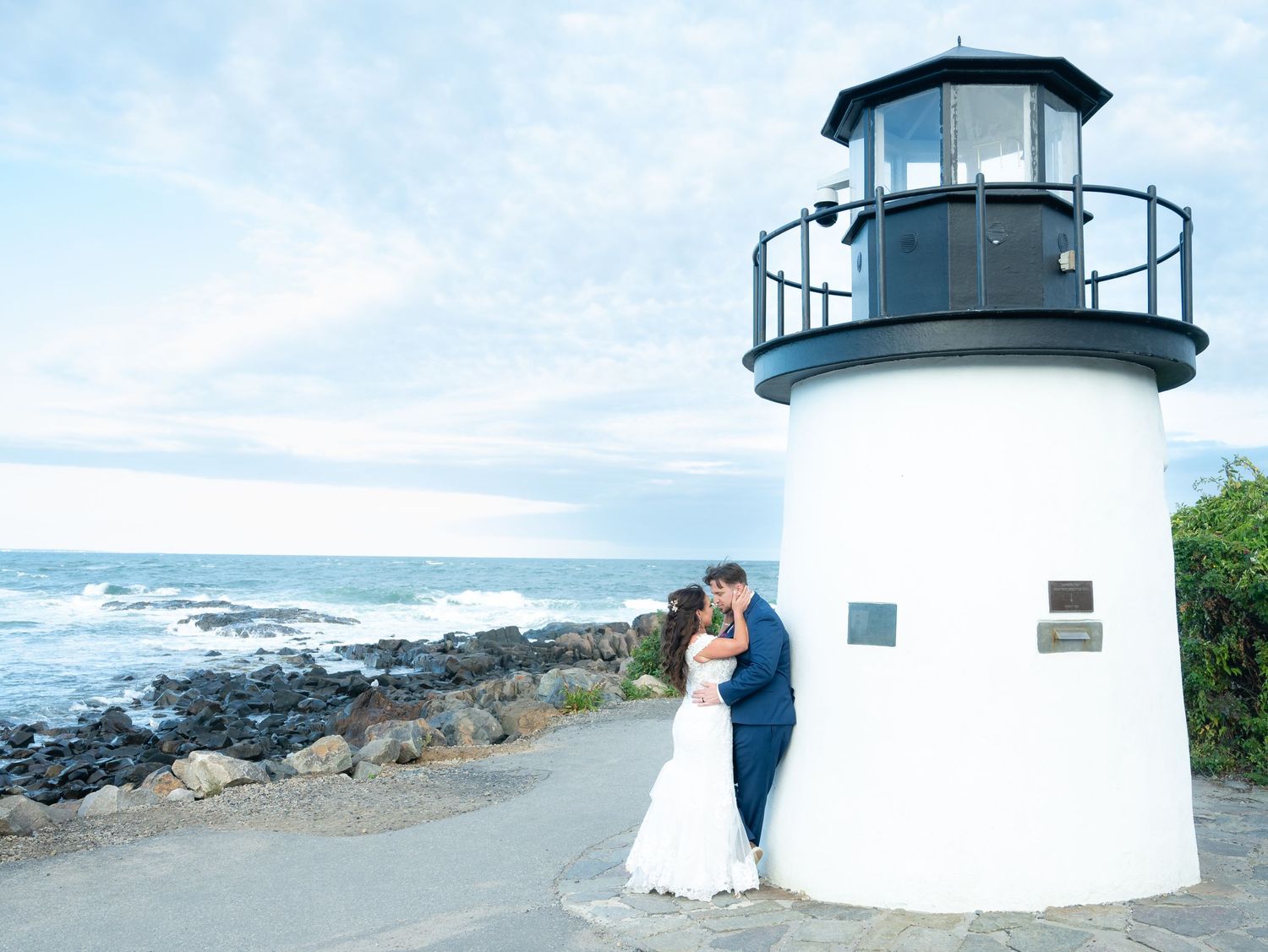 Lighthouse wedding photography series featuring coastal views and dramatic sky.