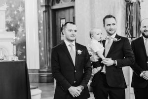 A formal church wedding ceremony with attendees in formal attire.