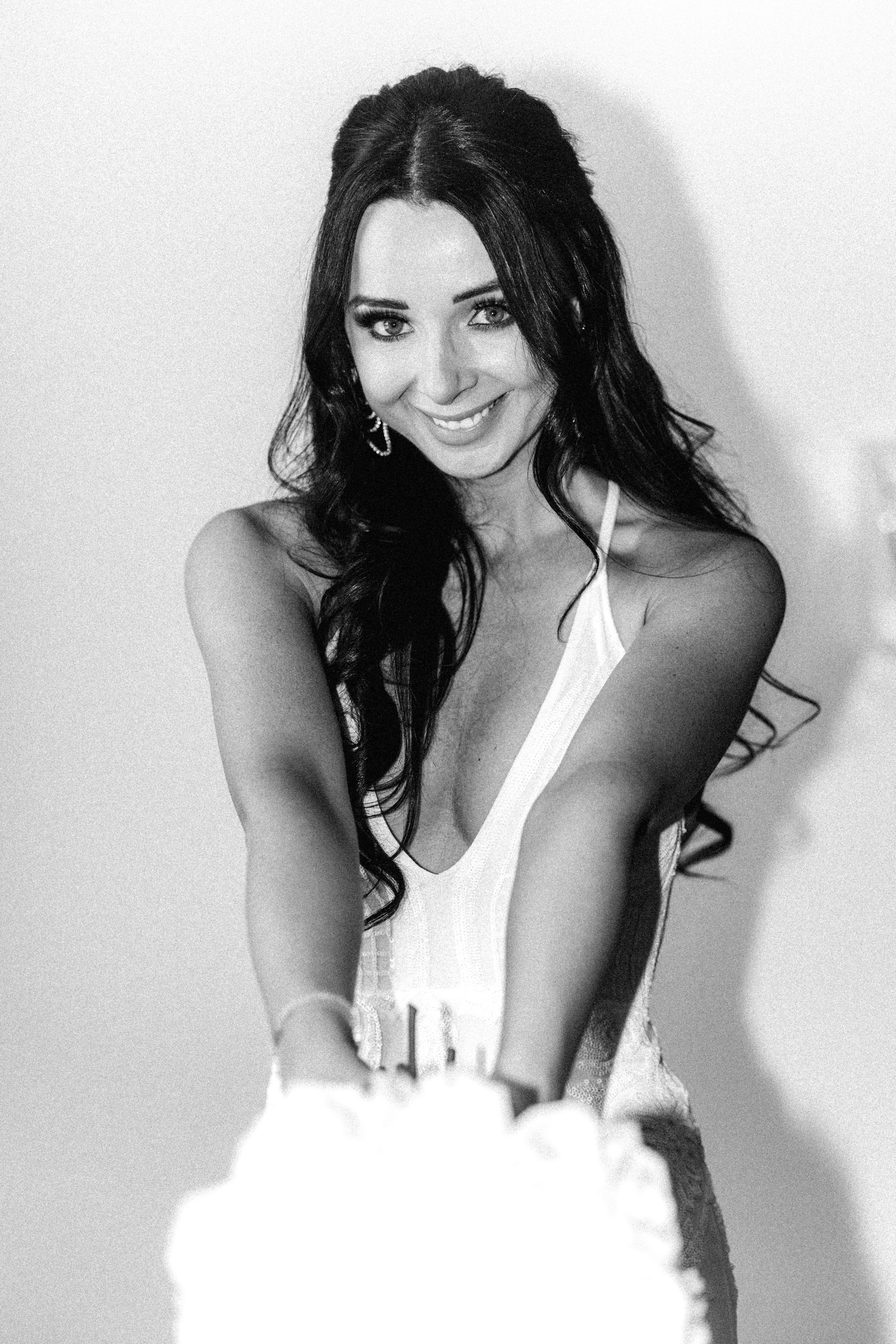 Black and white portrait of a bride in an elegant white gown.