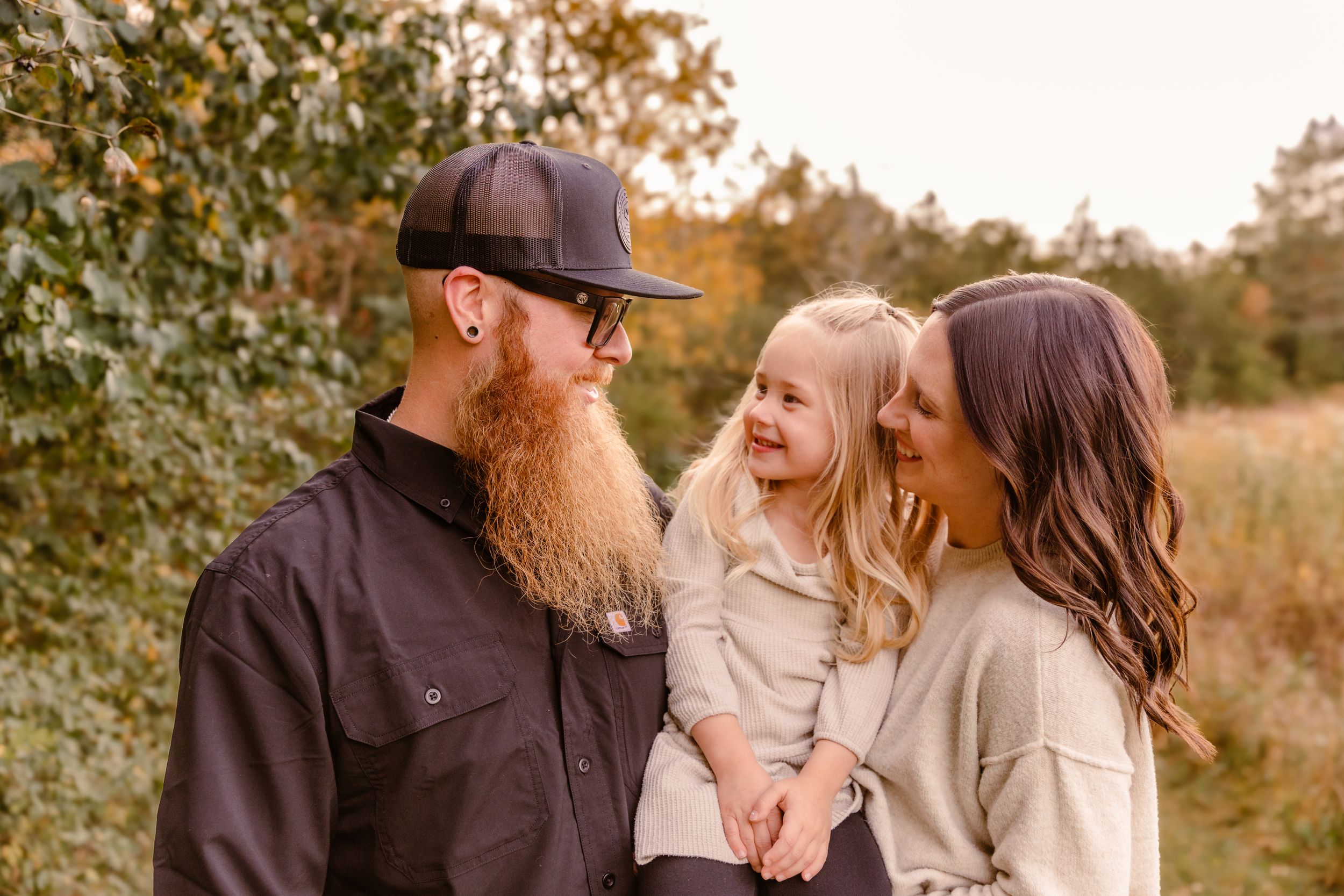 A couple shares playful moments together during a fall photoshoot.