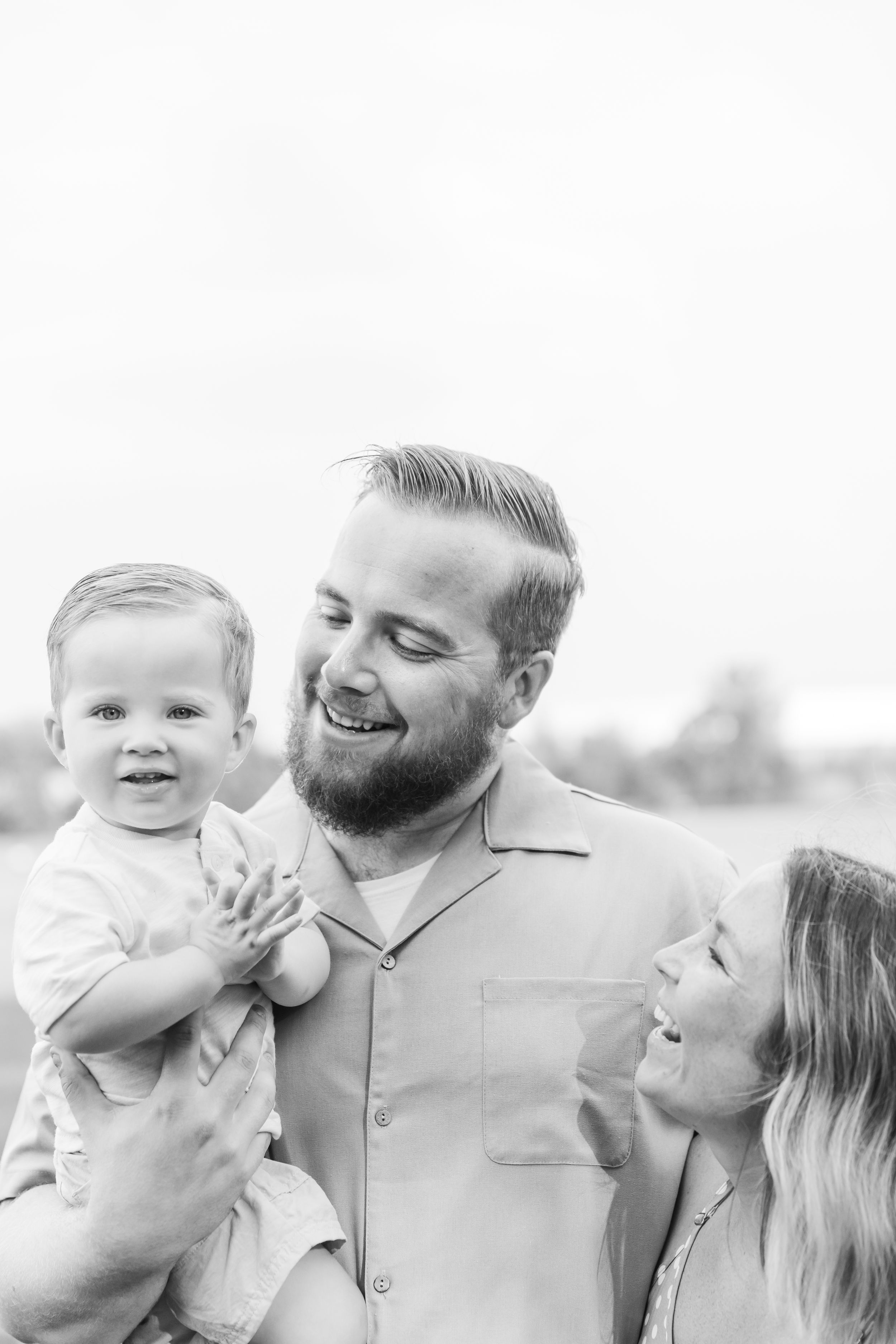 Family sharing joyful moment together against white background.