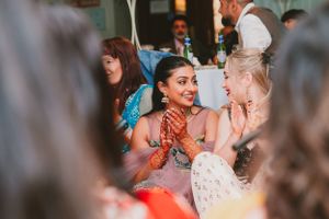 Guests share animated conversations during a formal celebration event with traditional attire.
