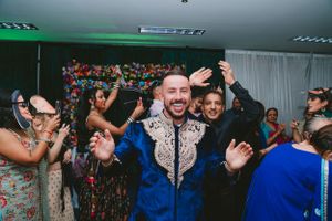 Guests celebrating at a party with blue traditional attire and festive atmosphere.