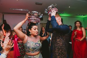 Couple performing a traditional crown dance ritual at a celebration.