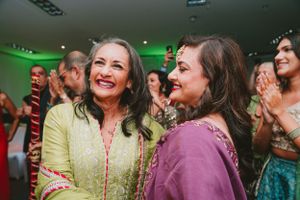 Party guests share joyful moment during indoor celebration.
