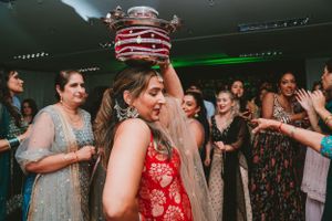 Guests celebrate at a lively party with decorative red and white striped poles as party props.
