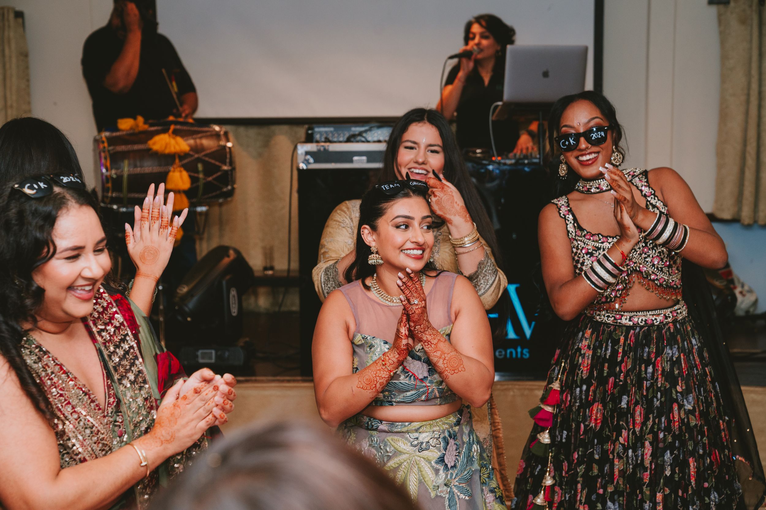 Group of guests celebrating and laughing together at an indoor party.