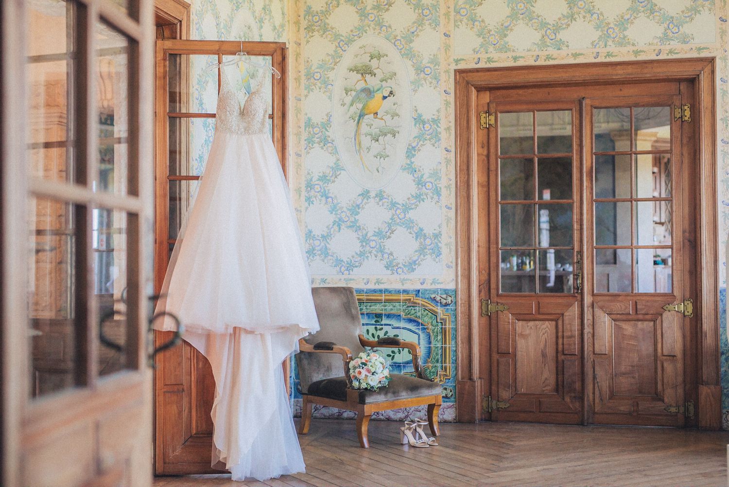 blush wedding gown displayed in an elegant French-style room at Casa dos Penedos. Captured by a destination wedding photographer in Lisbon