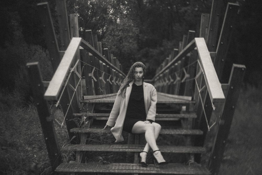 Black and white photo series of someone sitting on wooden bench in nature setting.