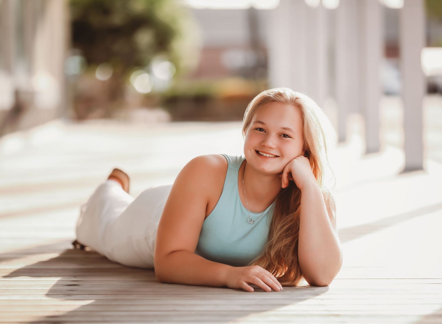 A series of indoor lifestyle portraits showing a person lying on a white surface in natural light.