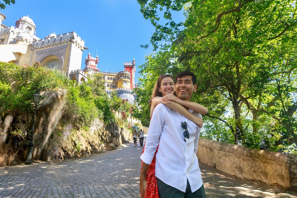 Winding garden pathway through lush greenery at the historic Pena Palace grounds in Sintra.