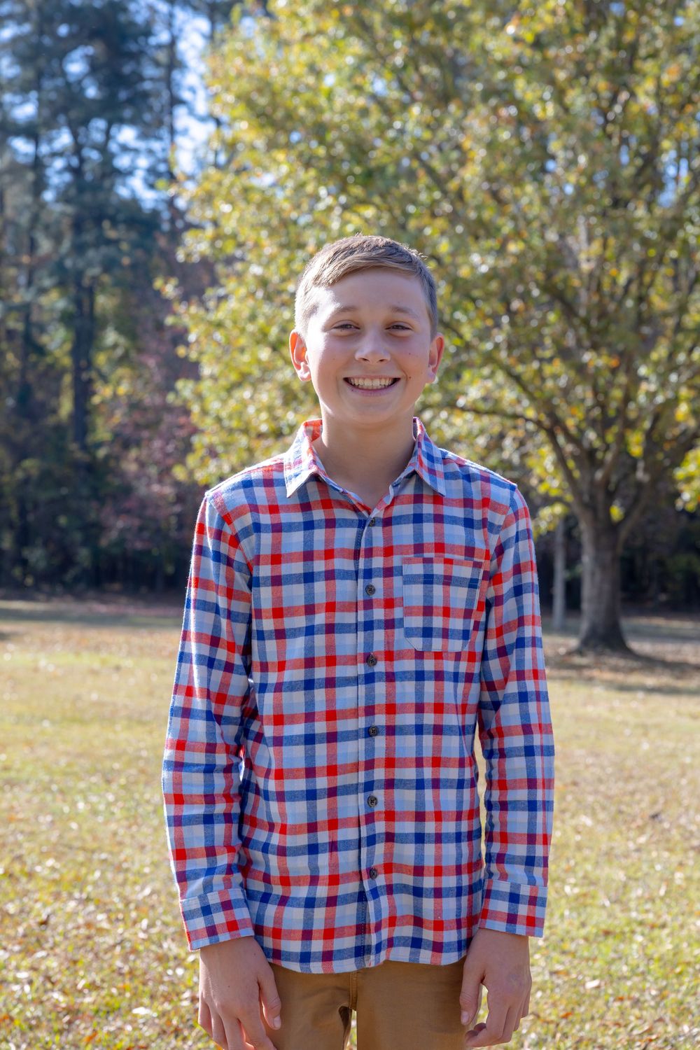 A series of outdoor portrait shots showing a person in a red and blue plaid shirt against an autumn background.