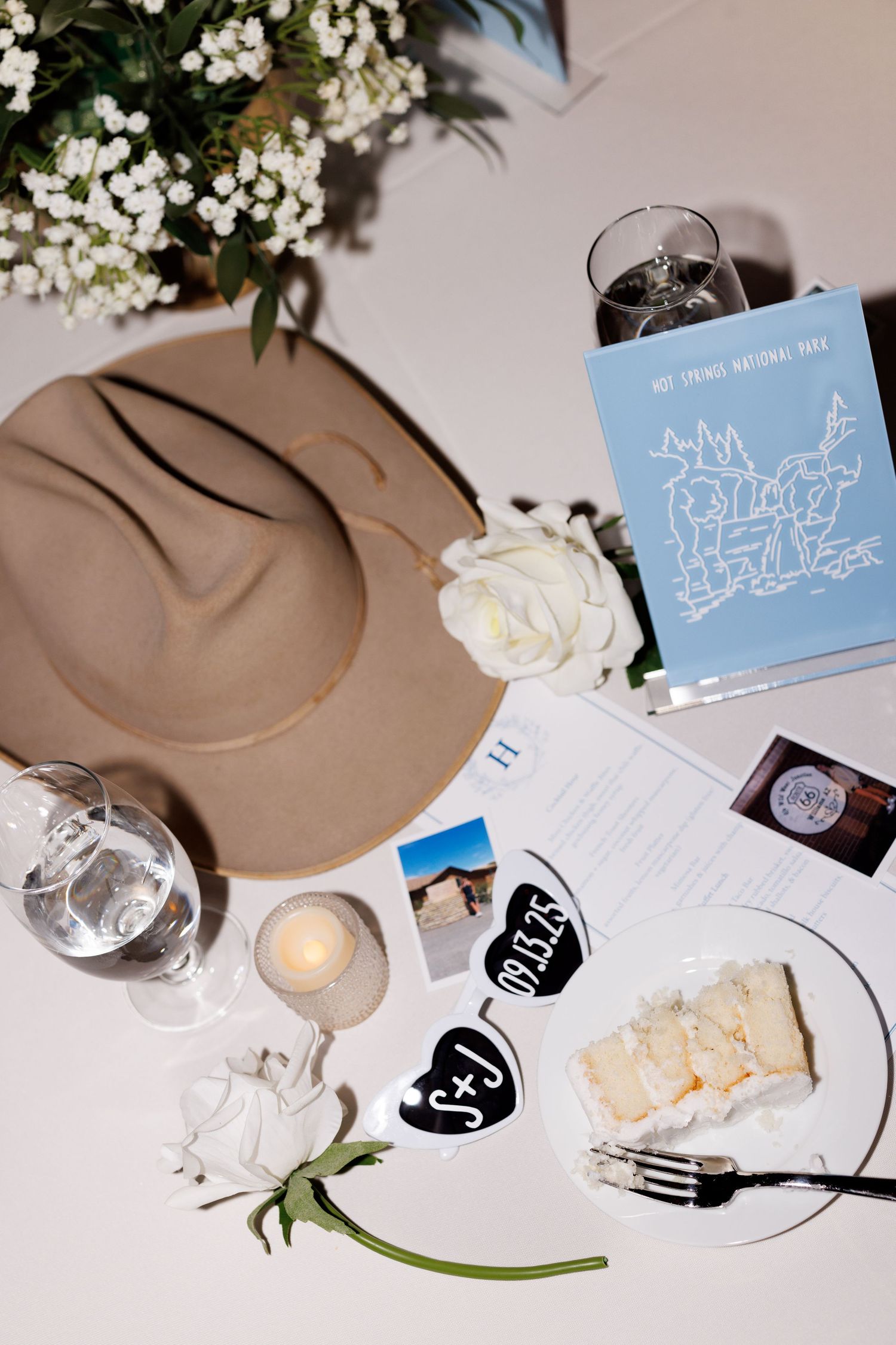 Wedding reception table details with place cards, flowers and decorative elements.