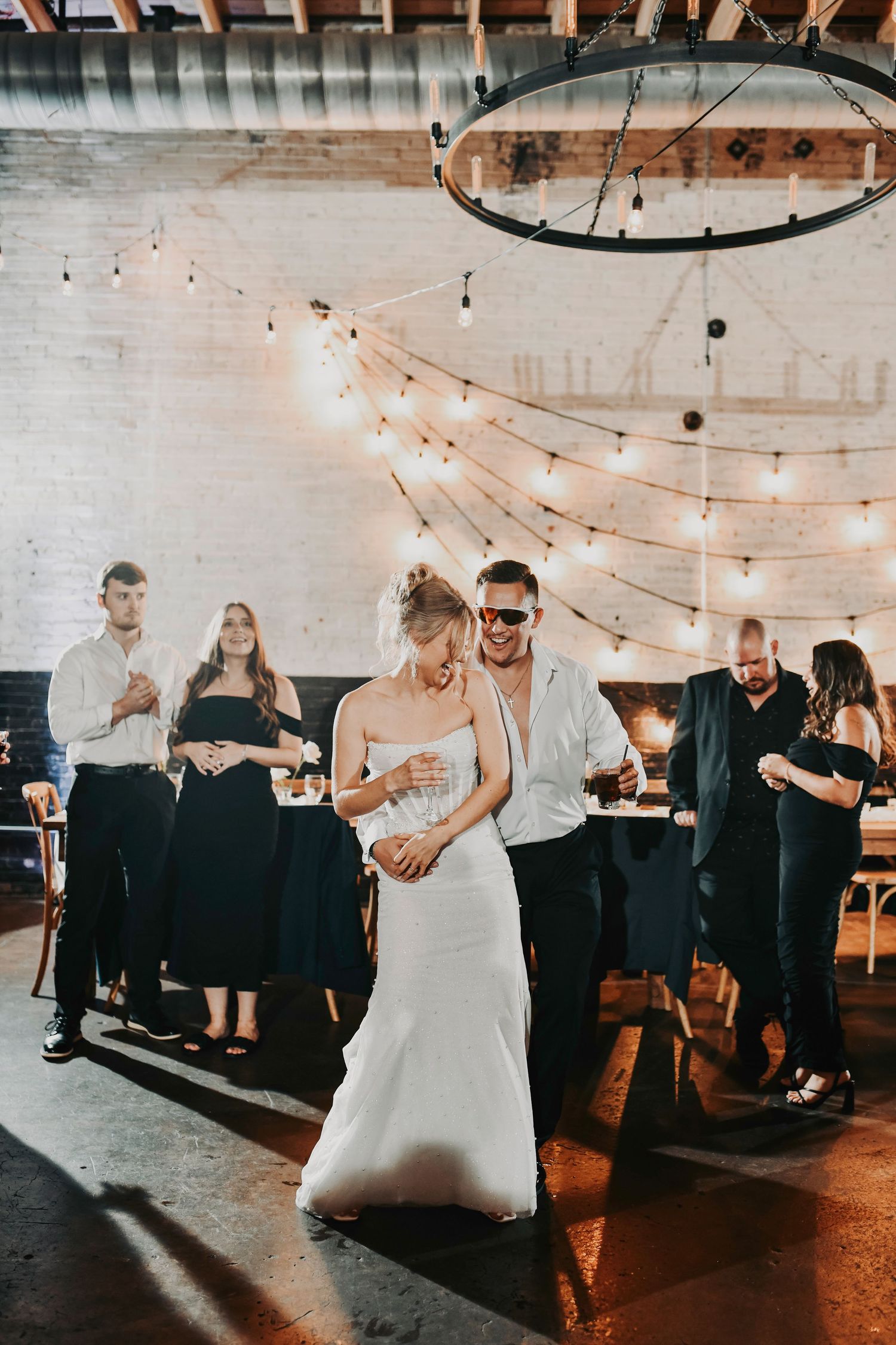 Bride laughing joyfully while dancing with her groom at their Dallas wedding reception.
