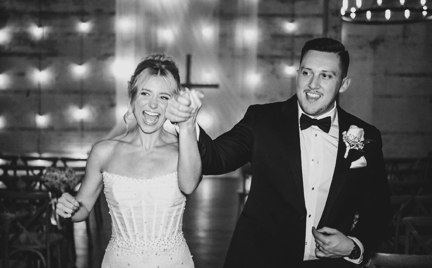 Groom spins the bride across the dance floor in an energetic, joyful moment.