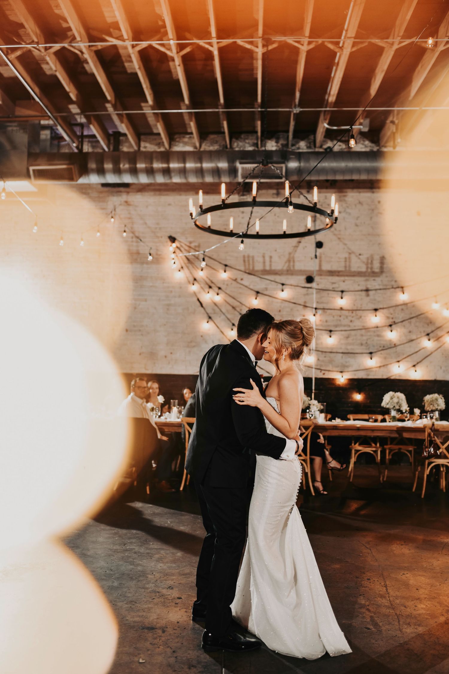 Editorial-style first dance with soft motion blur and direct flash at Brake & Clutch Warehouse.