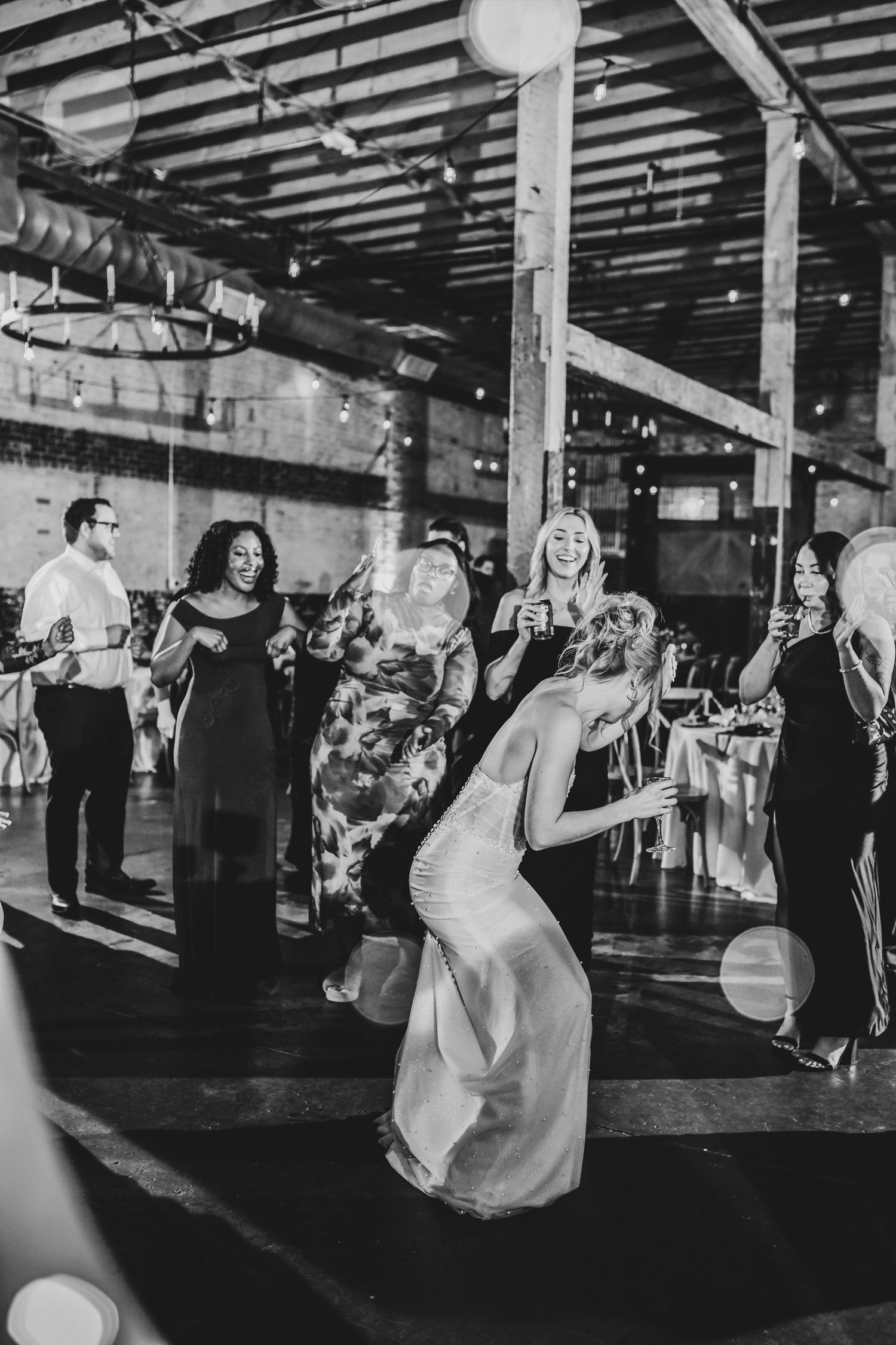Editorial-style wedding dance with the bride laughing in her groom’s arms.