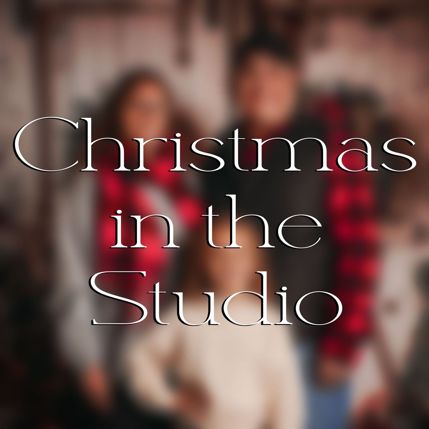 White script text reading 'Christmas Studio' overlaid on a blurred festive background.