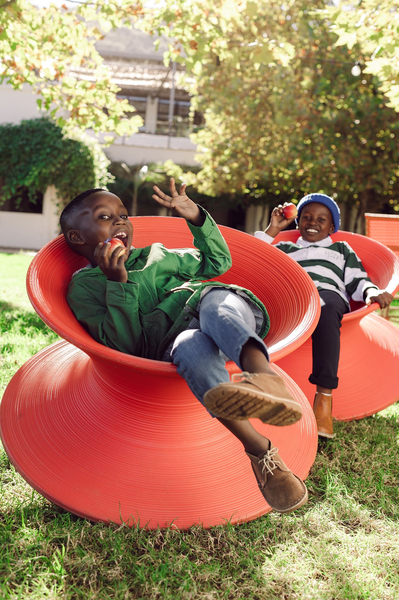 Two boys in playground showing off Jazz Apples