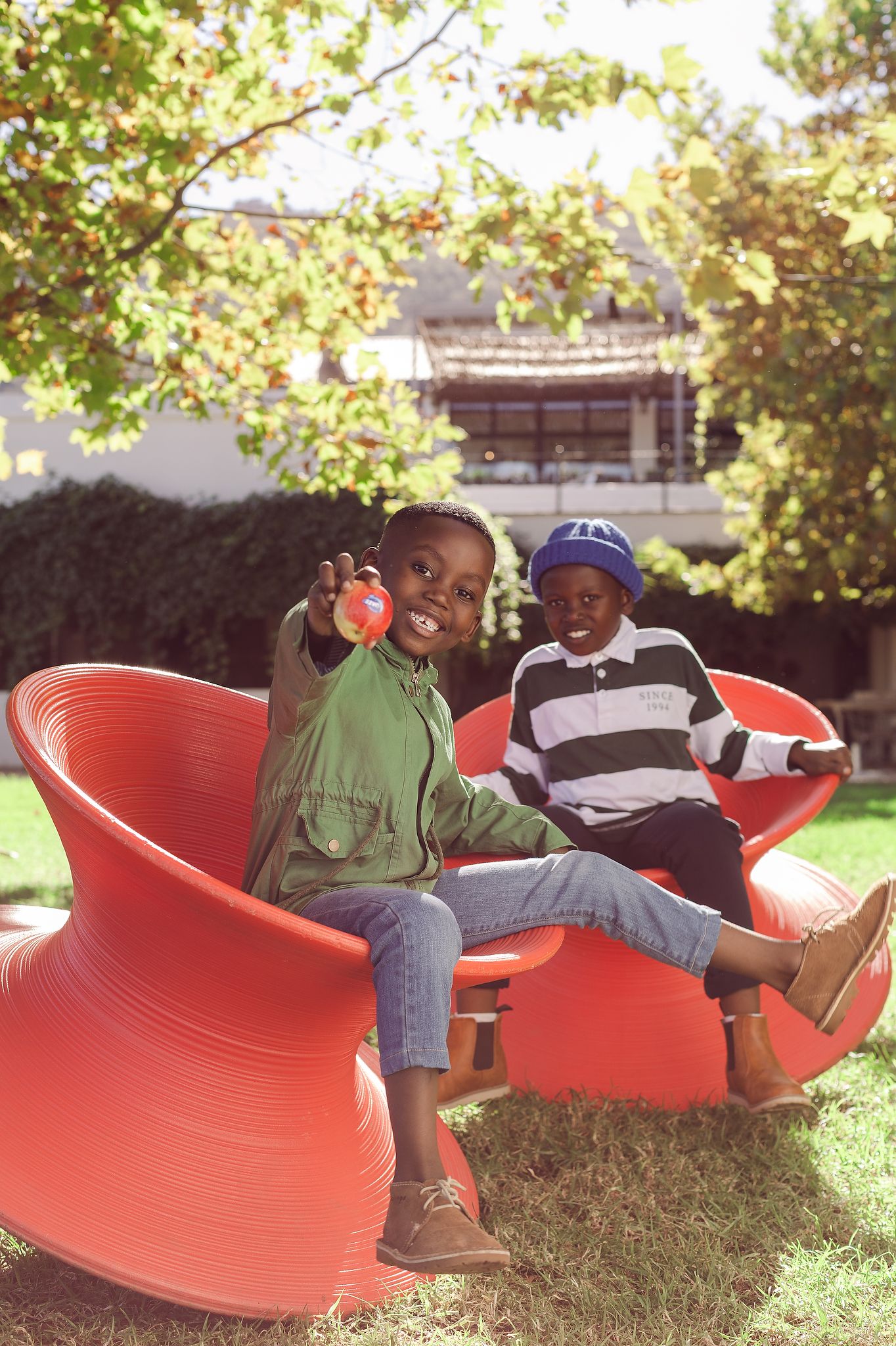Two boys in playground showing off Jazz Apples