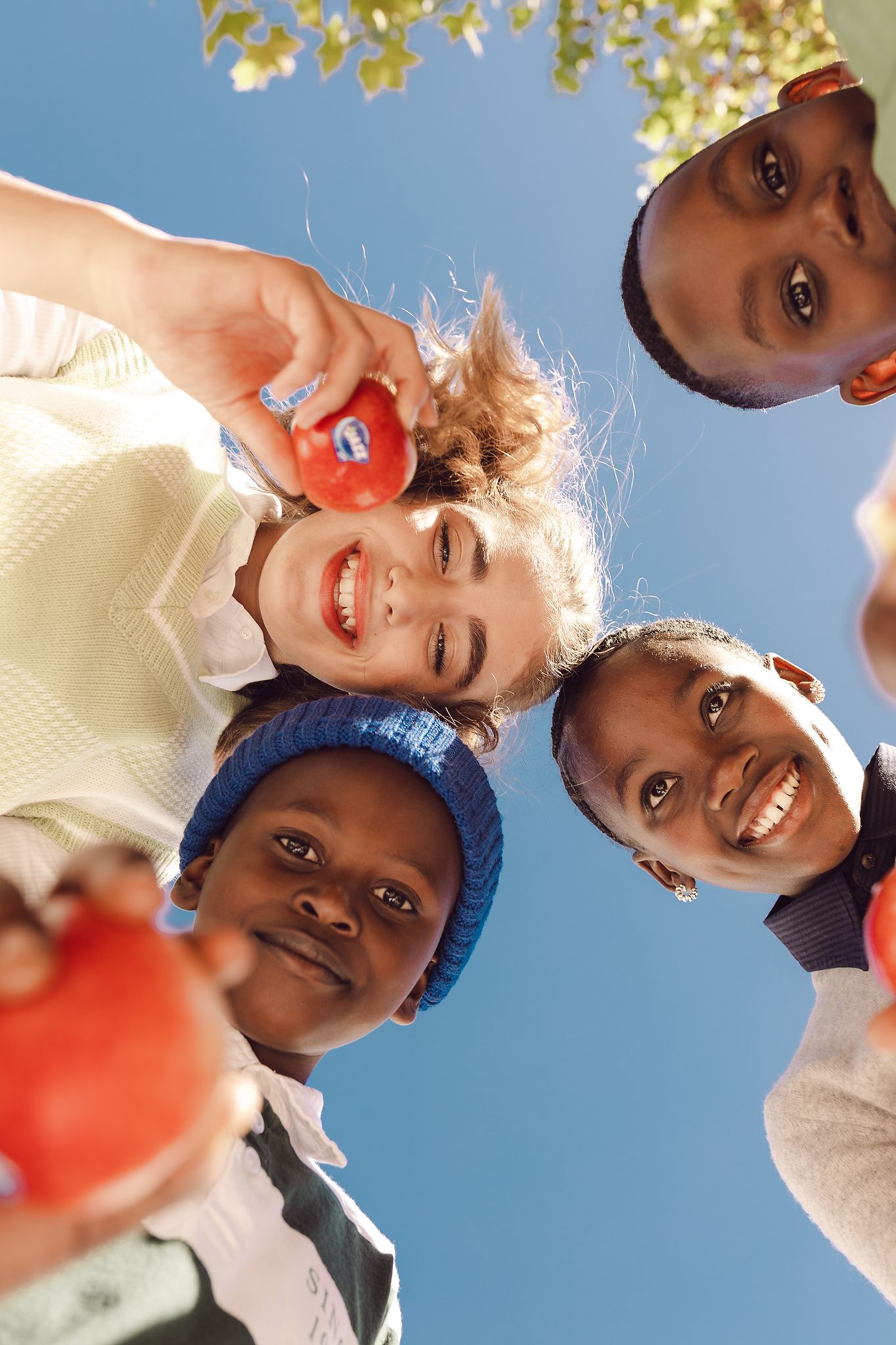 Shot from bottom, showing happy faces with Jazz Apples