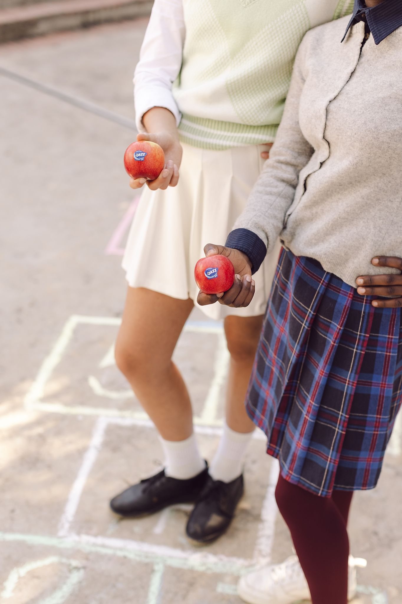 School girl shot in playground, close up of Jazz Apple