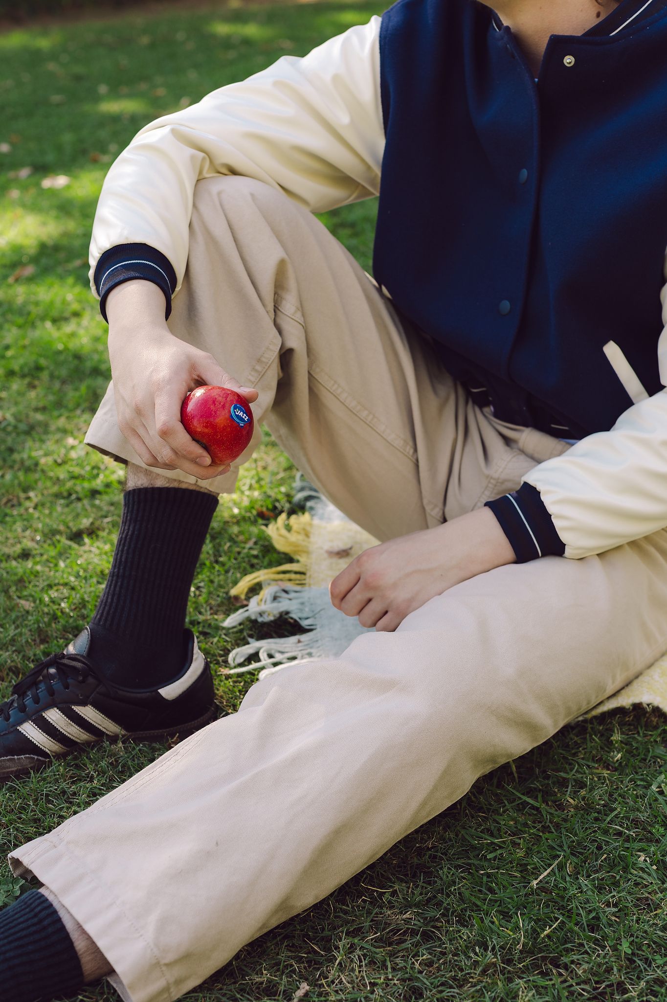 Close up of young man holding a Jazz Apple