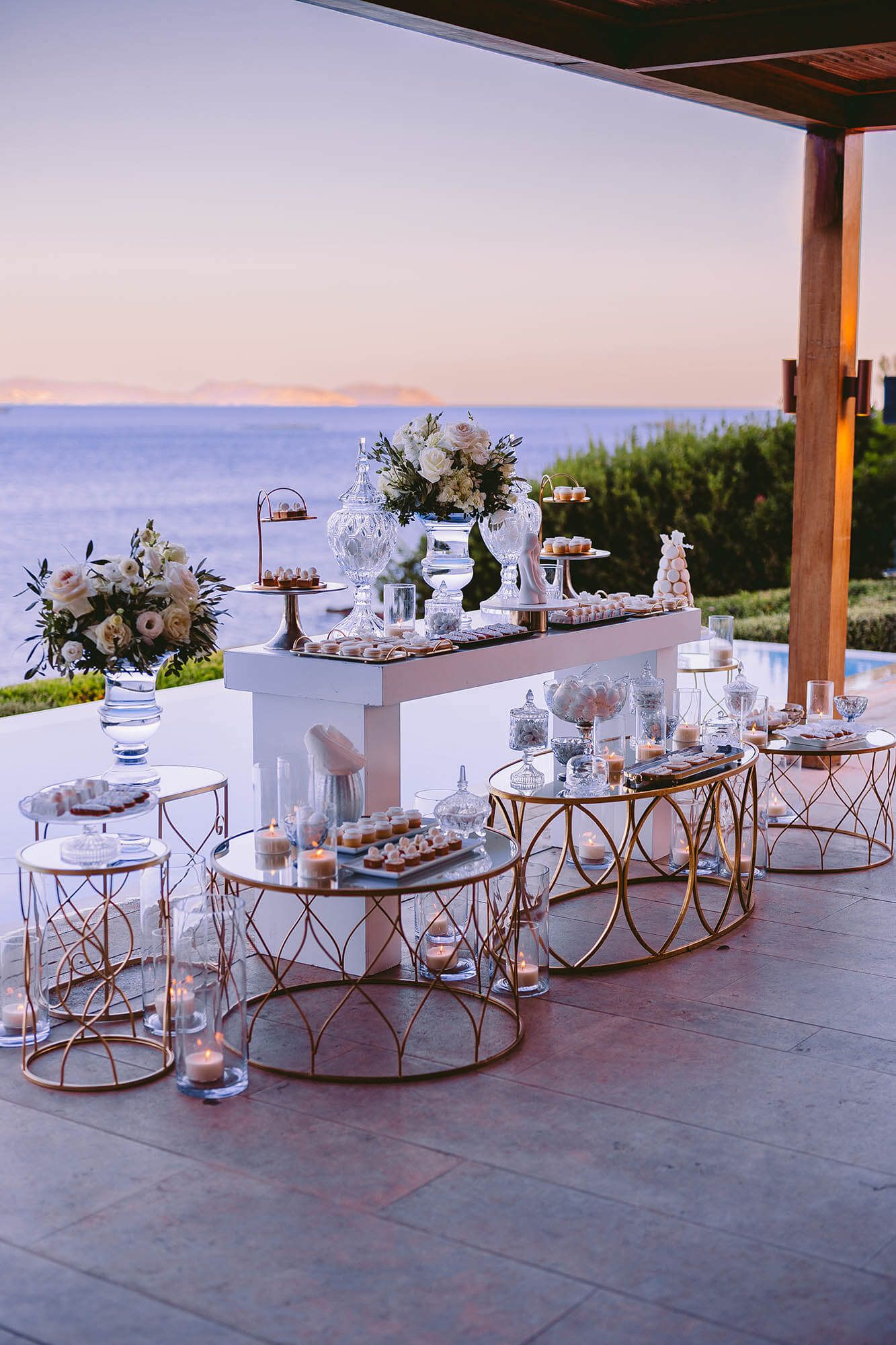 elegant wedding dessert table decoration with sea view at sunset in Island Athens Riviera