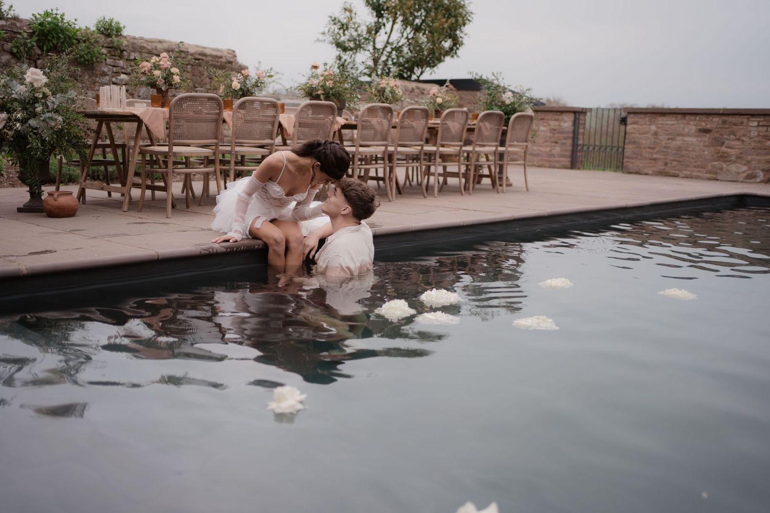 Couple sharing a relaxed moment together in a swimming pool during a photoshoot