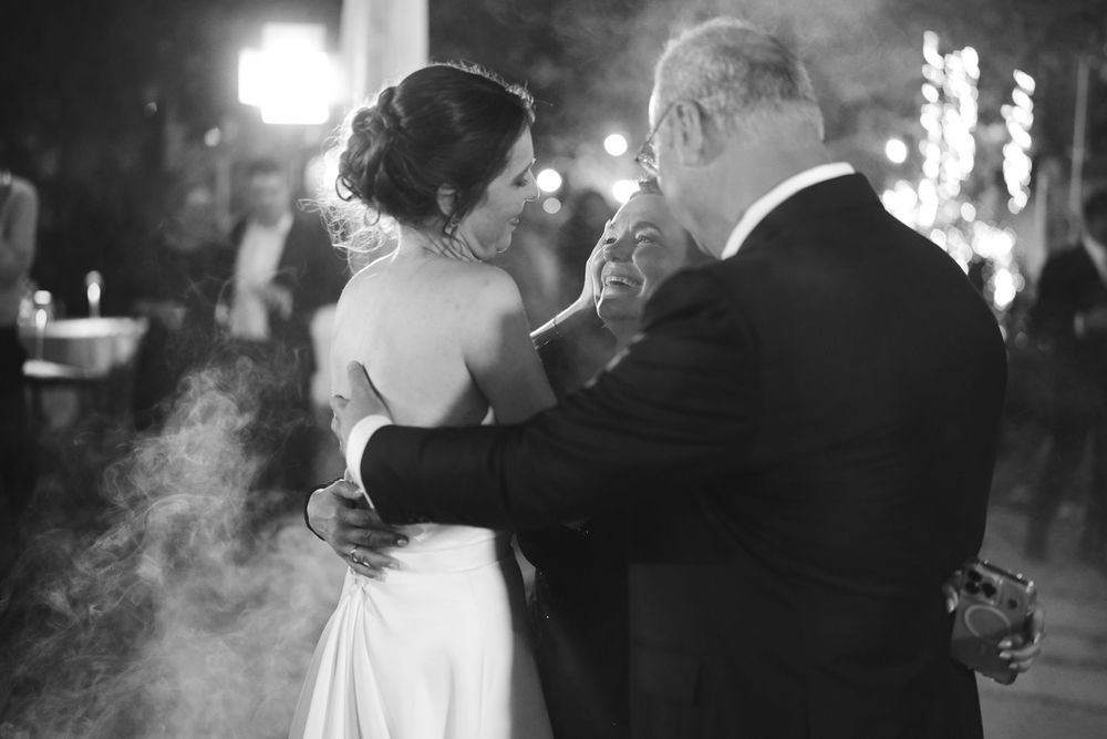 the bride dances with her mother and father during the wedding at the locanda del cavaliere
