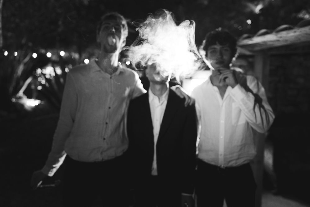 Guests smoke cigars during the wedding at the locanda del cavaliere
