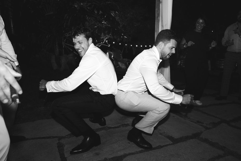 the groom dances with his friend at the locanda del cavaliere