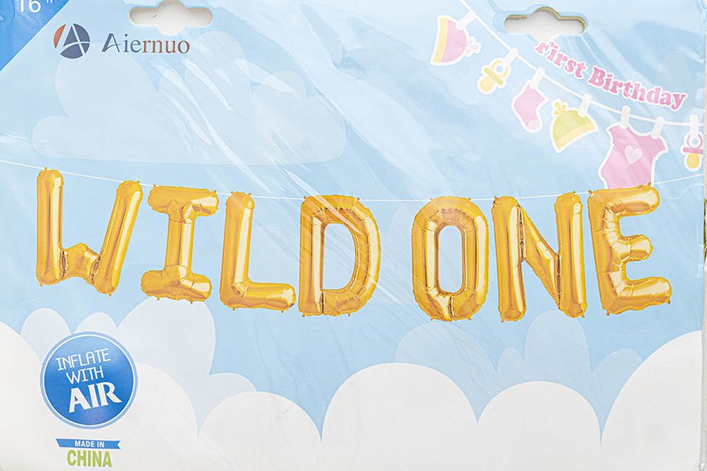 Gold foil WILD ONE balloon letter banner for first birthday party decoration.