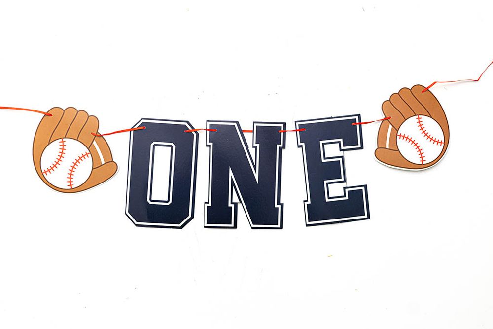 Baseball-themed ONE first birthday banner for My Rookie Year cake smash photoshoot.