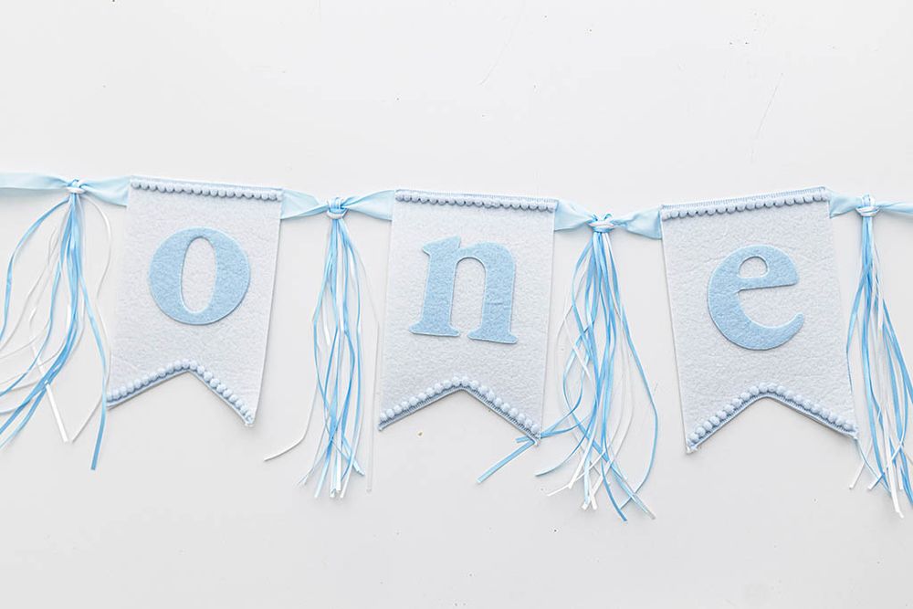 Blue and white felt ONE letter banner for first birthday photography in Menifee California.