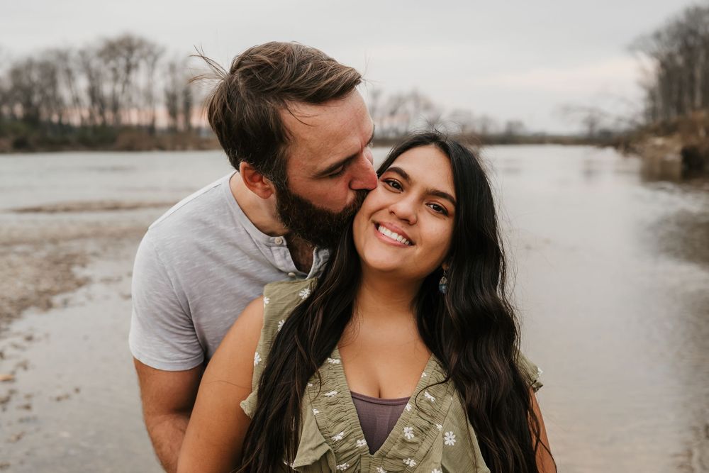 man kisses his soon to be bride during his engagement session in cincinnati