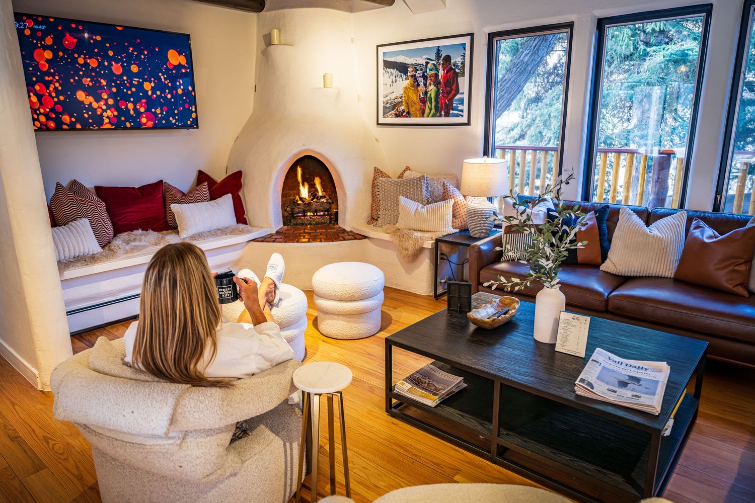 Shot of a woman sipping coffee at the luxury boutique hotel, the Eagle River Inn in Minturn, CO.