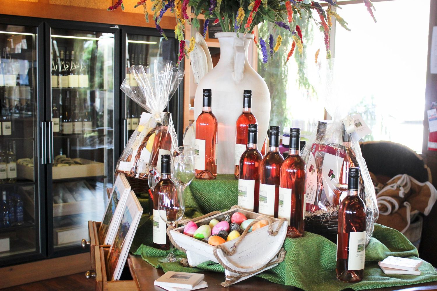 Display of wine bottles and gourmet items arranged in an elegant restaurant setting.