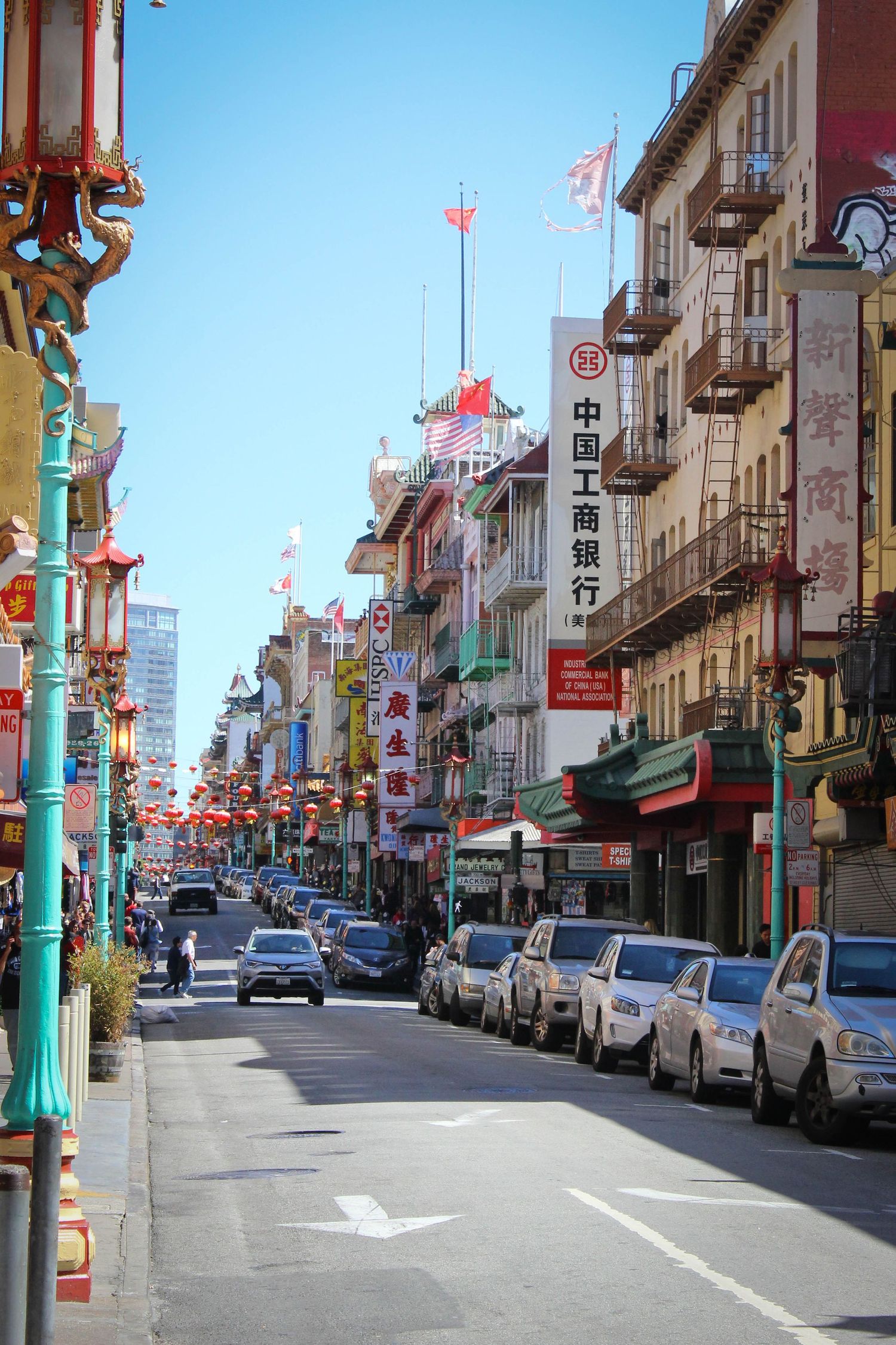 Vibrant street in San Francisco's Chinatown with traditional buildings and hanging lanterns.