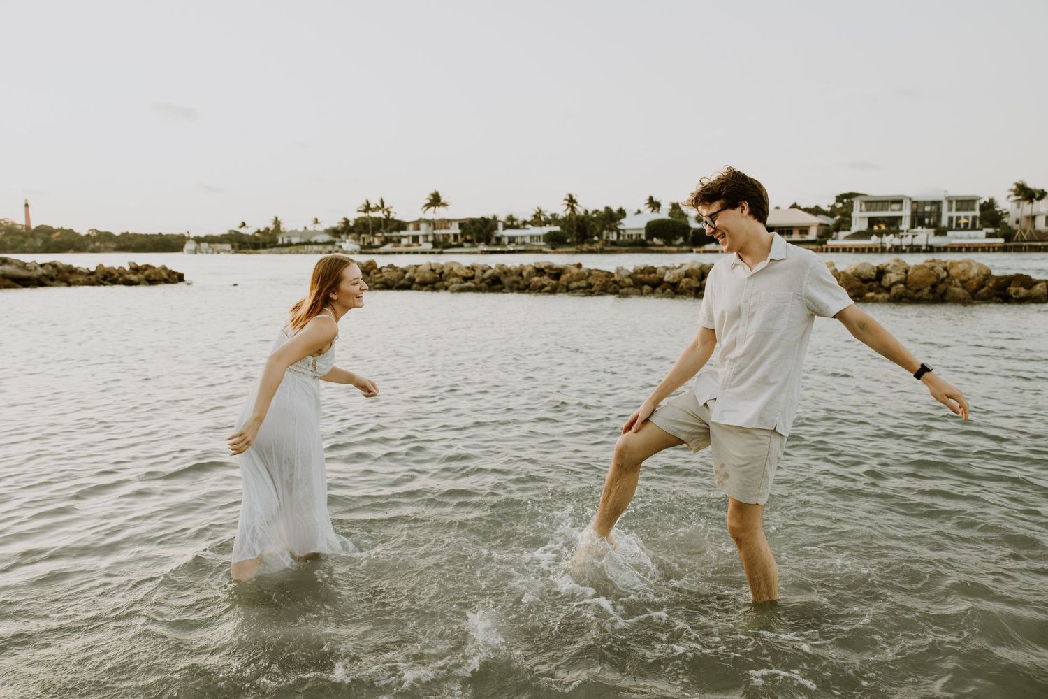 Engagement photos in Dubois Park, in Jupiter, Florida. Engagement photos of couple at the beach in water. Engagement photos in water.