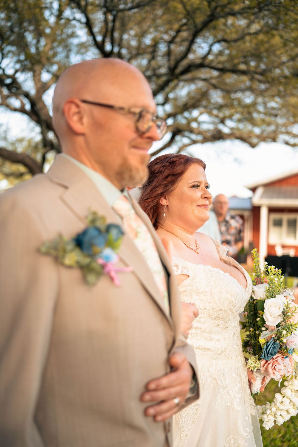 Elegant wedding couple embraces during outdoor sunset portrait session.