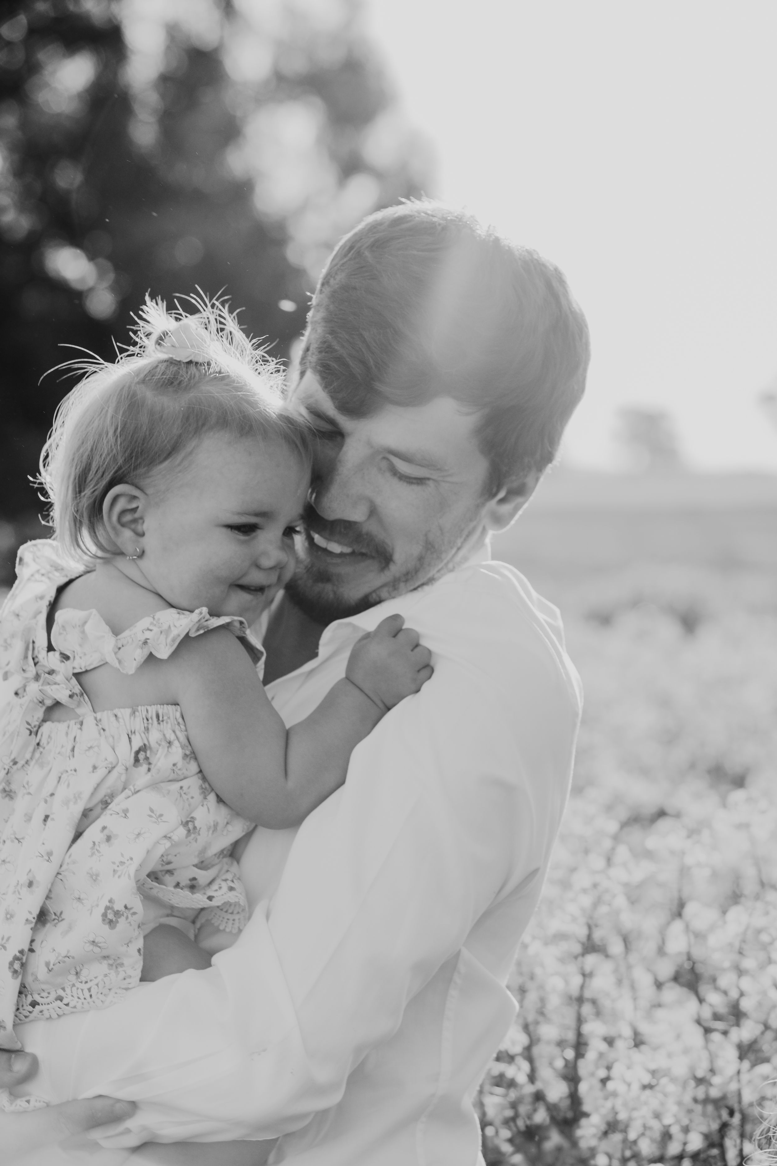 Tender moment captured in black and white among blooming flowers.