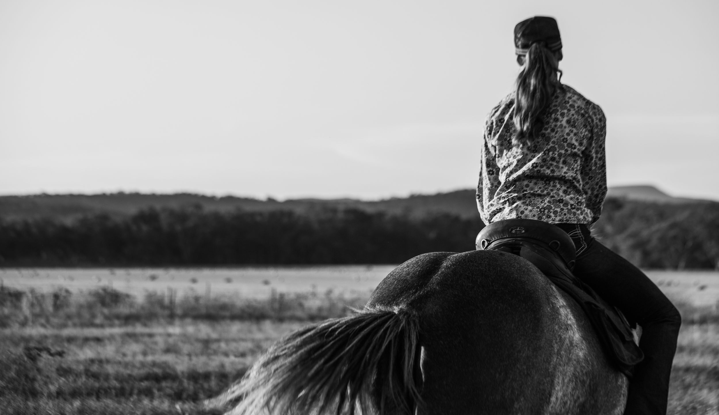 Horseback riding through scenic countryside at golden hour.