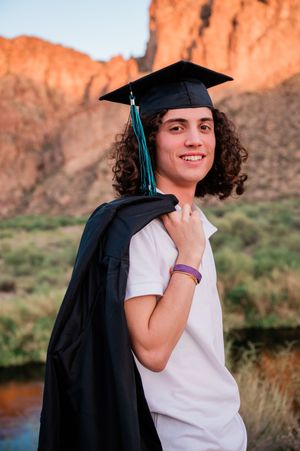 Gilbert Arizona photographer Melissa Maxwell of Jubilee Family Photography. High school senior boy in cap and gown at Water Users Recreation